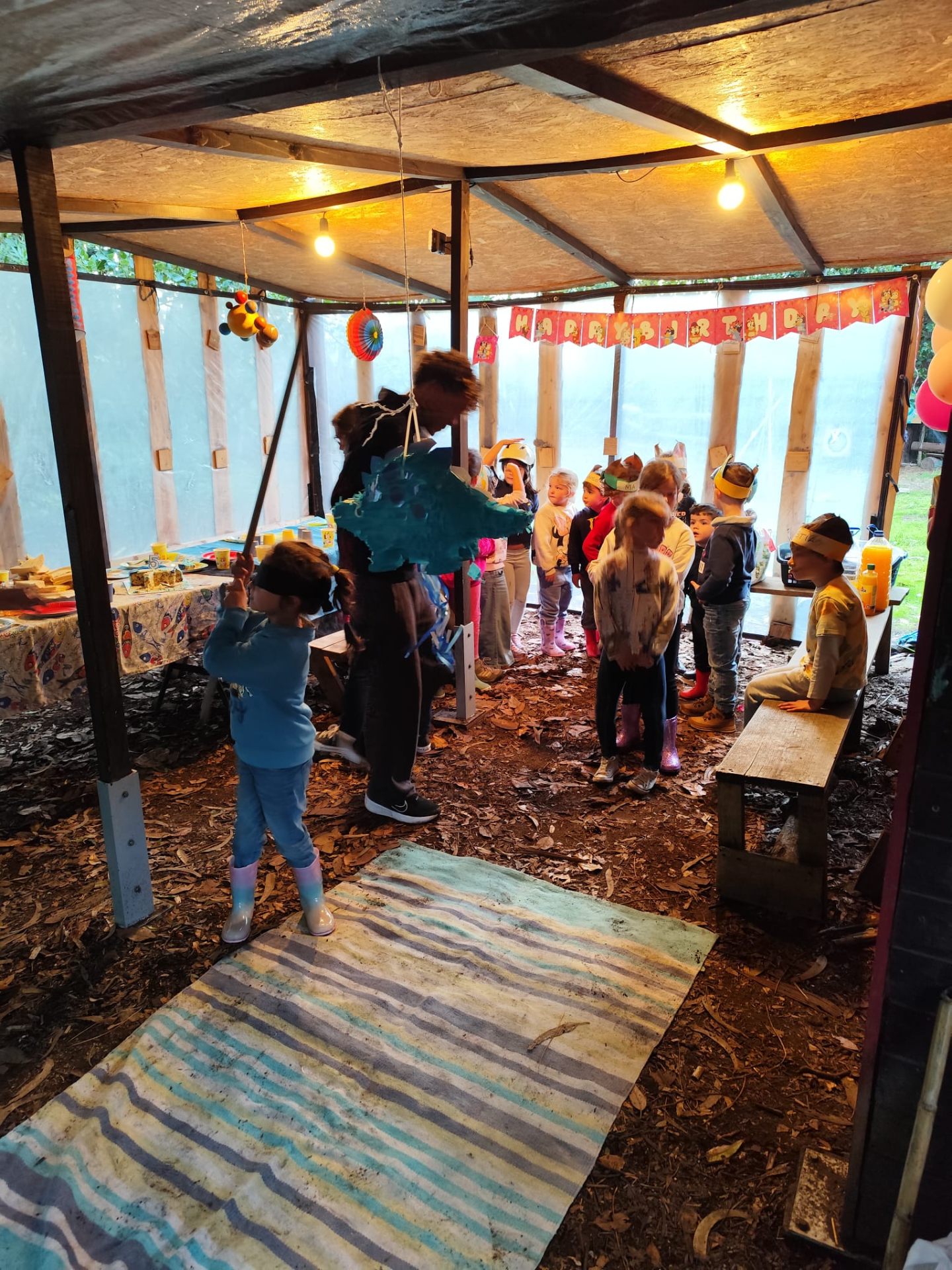 Crianças dentro de um abrigo construído na mata